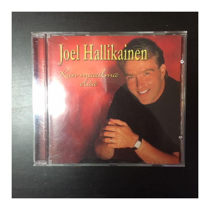 Joel Hallikainen - Kun maailma elää CD (VG+/VG+) -iskelmä-